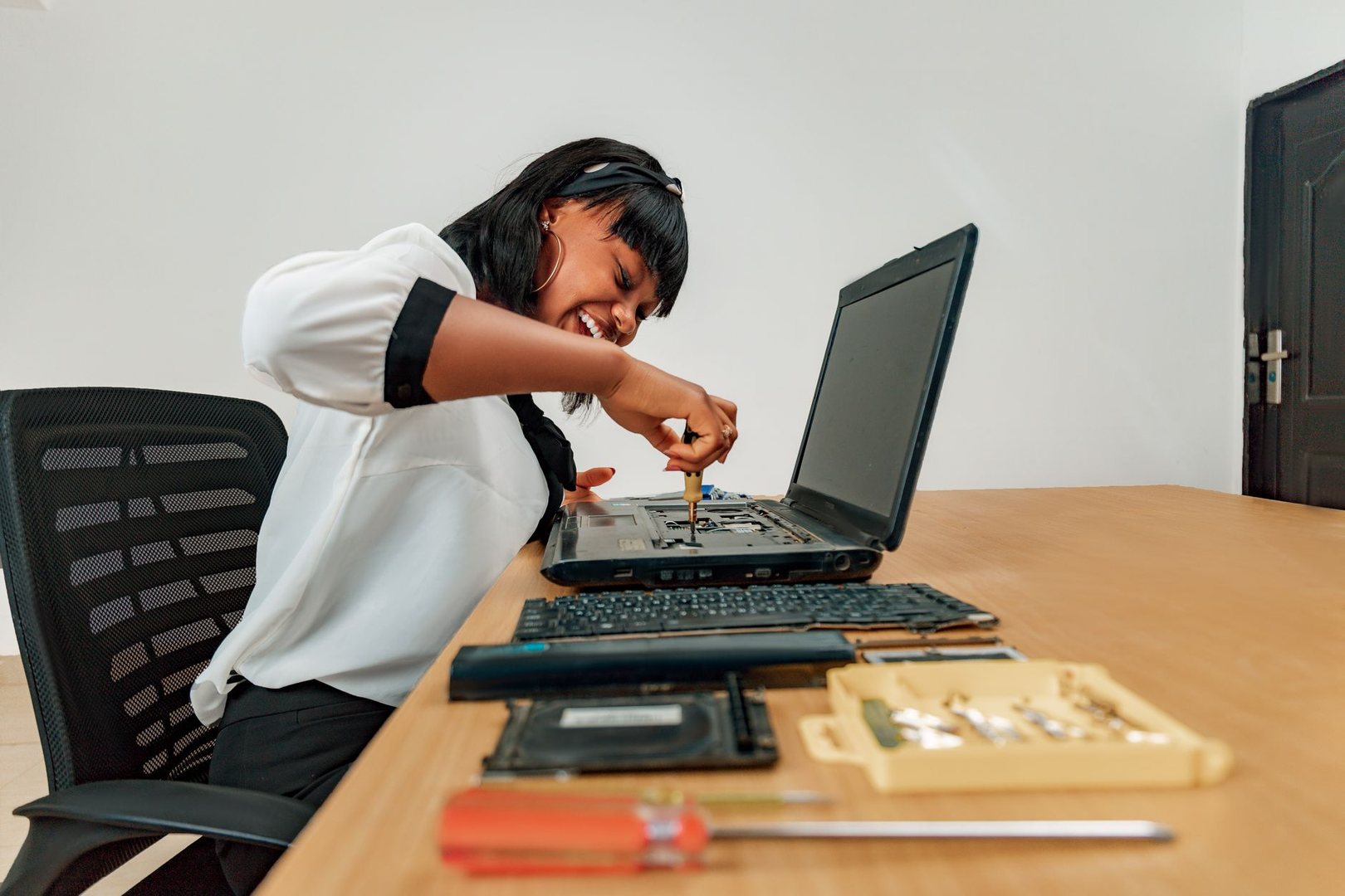 Someone looking after a website on a laptop (stock photo, replace when you have your own)